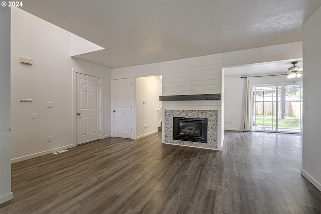 unfurnished living room with ceiling fan and dark hardwood / wood-style floors