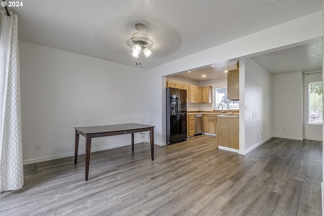 kitchen with dishwasher, ceiling fan, light brown cabinetry, light hardwood / wood-style floors, and black fridge with ice dispenser