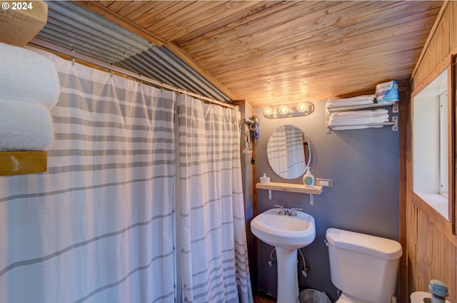 bathroom featuring toilet and wooden ceiling