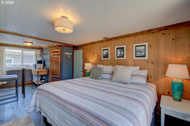 bedroom featuring wood walls and hardwood / wood-style flooring