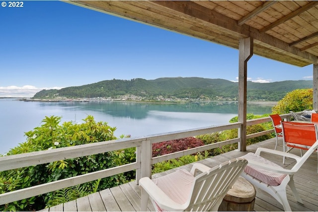 balcony featuring a deck with water view