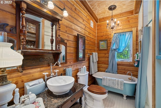 bathroom with a tub to relax in, wooden walls, sink, a notable chandelier, and toilet