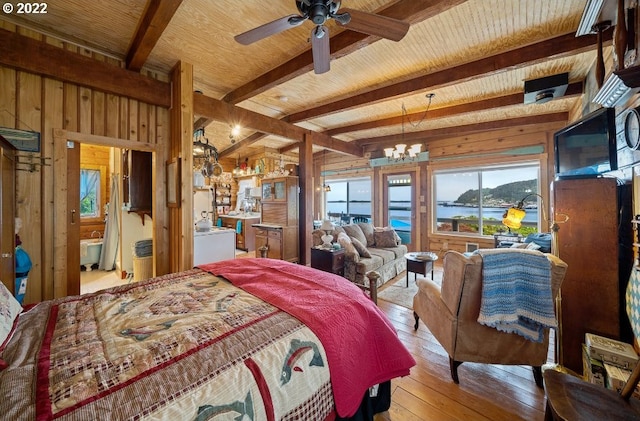 bedroom featuring wood walls, beamed ceiling, ceiling fan with notable chandelier, and light wood-type flooring