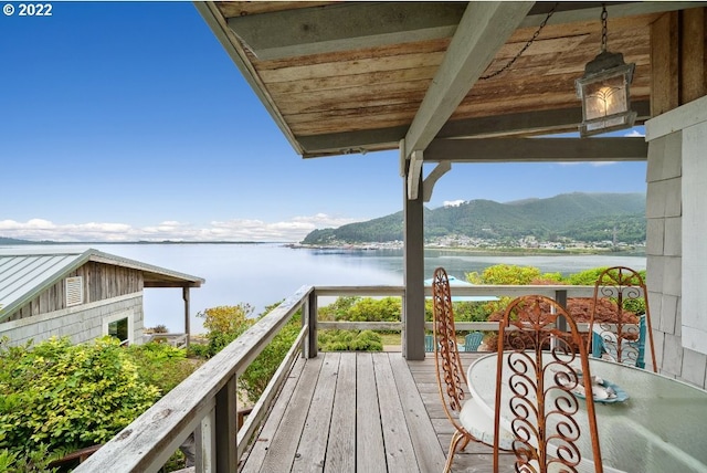 balcony with a water and mountain view