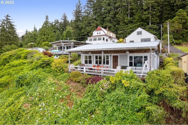 12880 Hobsonville Point Dr, Bay City, OR 97107 - rear view of house featuring metal roof and a forest view