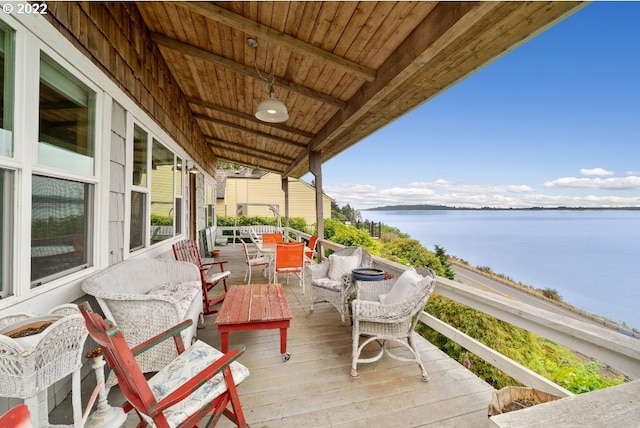 balcony with outdoor lounge area and a water view