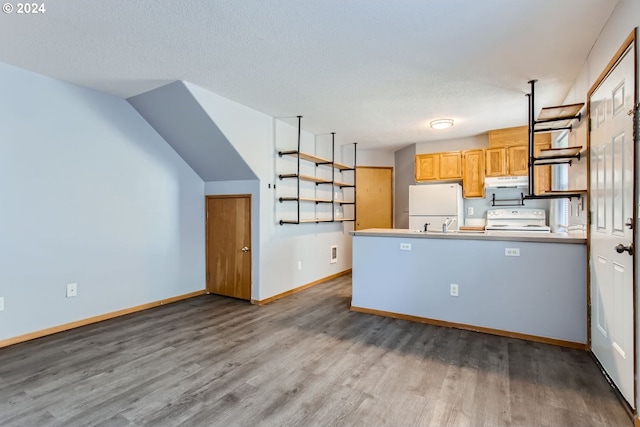 kitchen featuring hardwood / wood-style flooring, white appliances, kitchen peninsula, and a textured ceiling