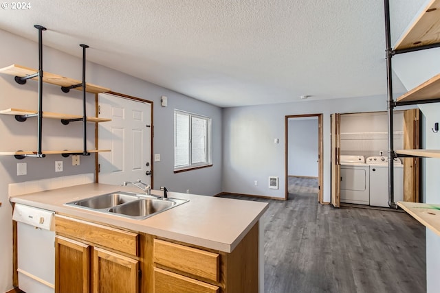 kitchen featuring sink, separate washer and dryer, dark hardwood / wood-style flooring, dishwasher, and pendant lighting