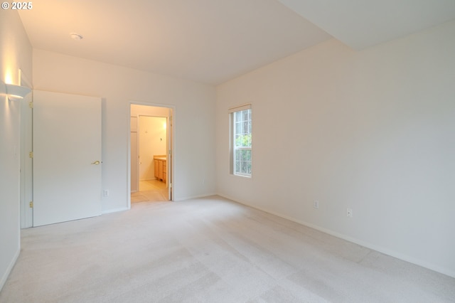 unfurnished bedroom with light carpet and baseboards