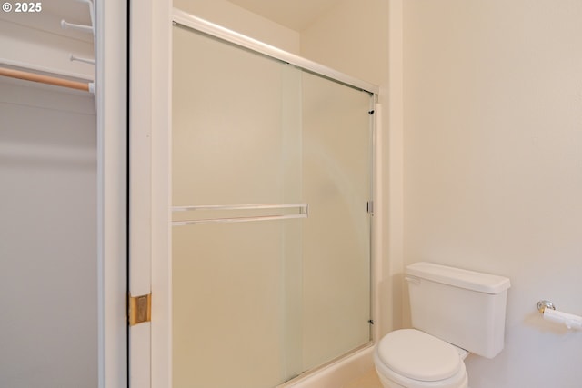 full bathroom with toilet and a stall shower