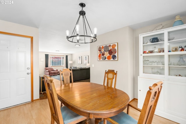 dining space with a chandelier and light wood-type flooring