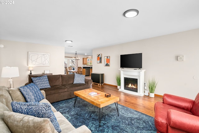 living room featuring a notable chandelier and hardwood / wood-style flooring