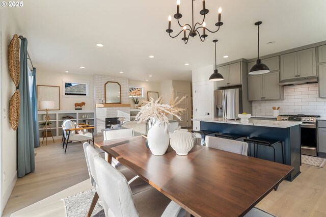 living room featuring a fireplace, plenty of natural light, and light wood-type flooring