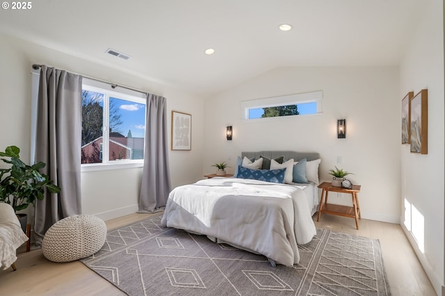 bedroom featuring lofted ceiling, recessed lighting, wood finished floors, visible vents, and baseboards