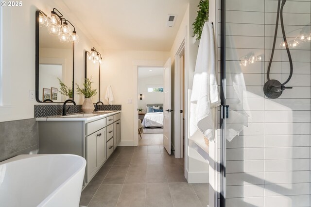 bathroom featuring tile patterned flooring, vanity, tile walls, and independent shower and bath