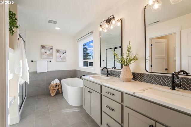 full bathroom with double vanity, a sink, and visible vents