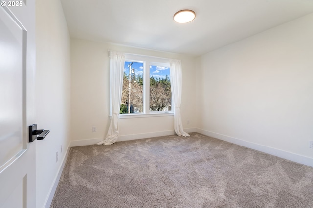 carpeted spare room with baseboards