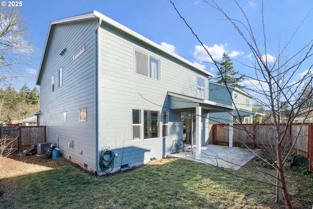 back of property with central AC unit, a patio, a fenced backyard, crawl space, and a yard