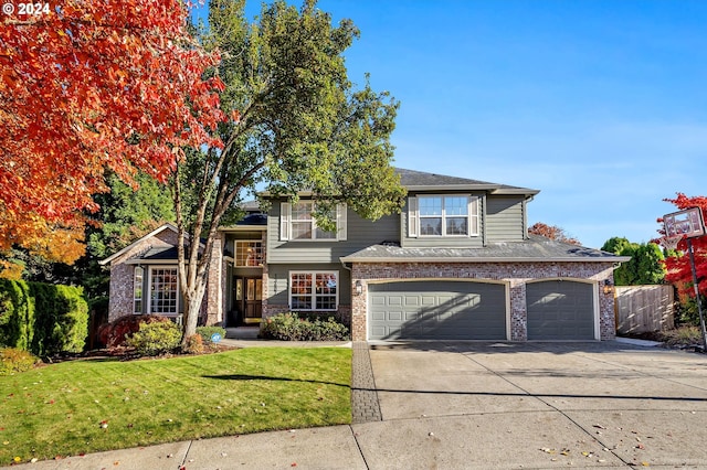 view of front of property with a garage and a front lawn