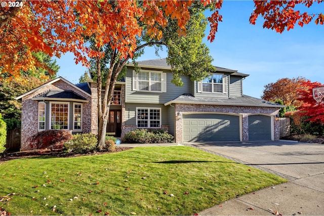 view of front property with a front yard and a garage