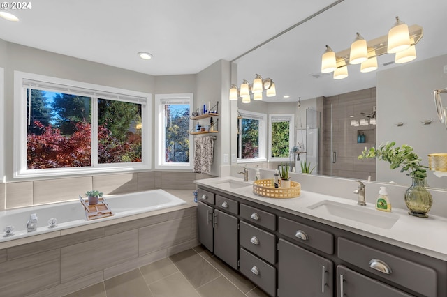 bathroom with tile patterned flooring, vanity, a healthy amount of sunlight, and independent shower and bath