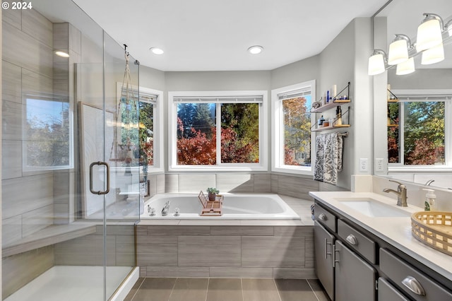 bathroom with tile patterned flooring, vanity, and independent shower and bath