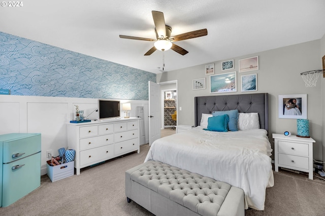 bedroom featuring light carpet and ceiling fan