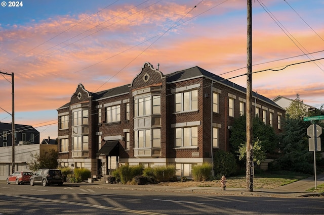 view of outdoor building at dusk