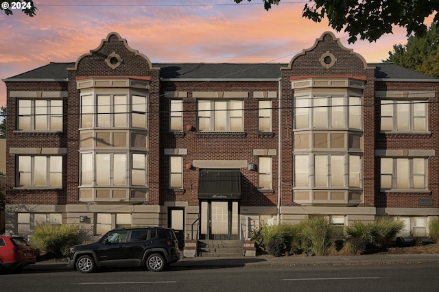 view of outdoor building at dusk