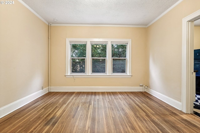 spare room featuring wood-type flooring, crown molding, and a textured ceiling