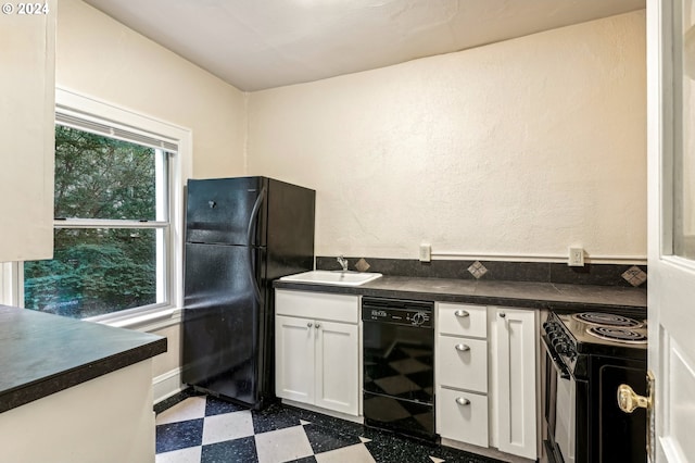 kitchen with black appliances, sink, and white cabinets