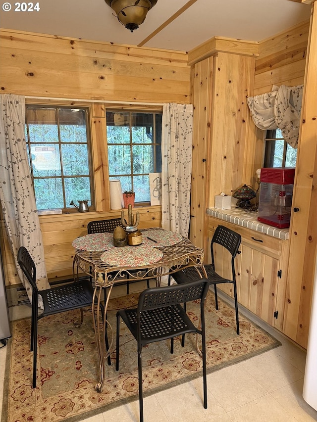 dining room with wooden walls