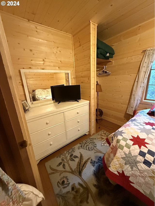 bedroom featuring wood walls and wooden ceiling