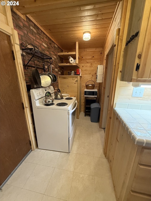 laundry area with wooden ceiling and brick wall