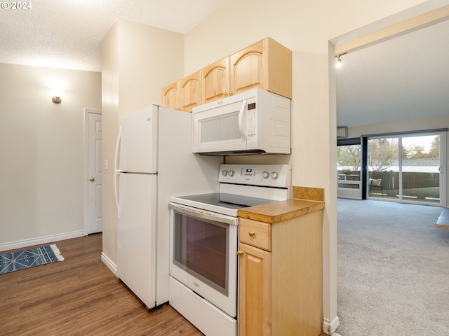 kitchen featuring white appliances, light hardwood / wood-style flooring, a textured ceiling, and light brown cabinets