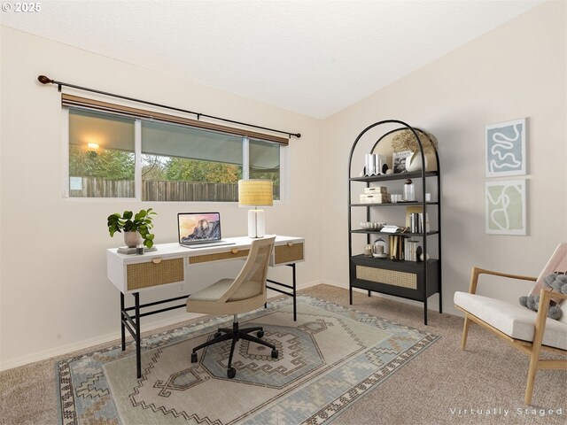 carpeted empty room featuring lofted ceiling and a textured ceiling