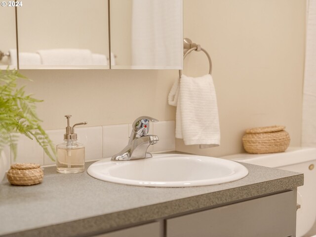 kitchen featuring white dishwasher, sink, and light brown cabinets