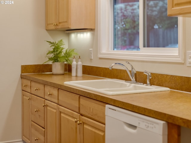 kitchen with dishwasher, sink, and light brown cabinets