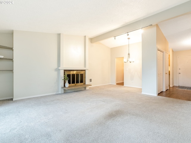 unfurnished living room featuring a chandelier, carpet, and lofted ceiling with beams