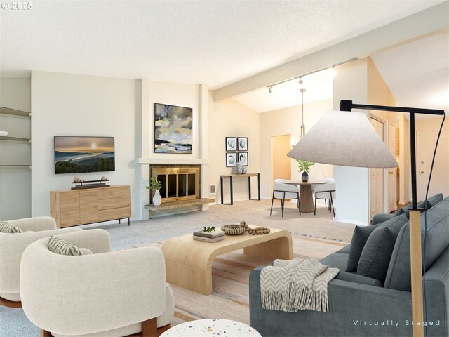 unfurnished living room with carpet, vaulted ceiling with beams, track lighting, and a textured ceiling