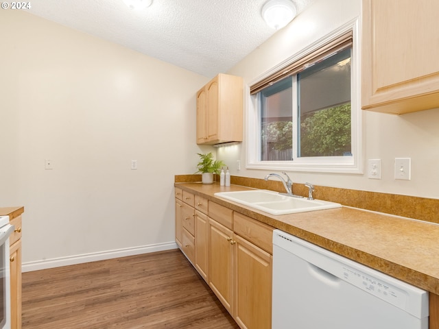 kitchen featuring sink, a textured ceiling, light brown cabinets, dishwasher, and hardwood / wood-style flooring