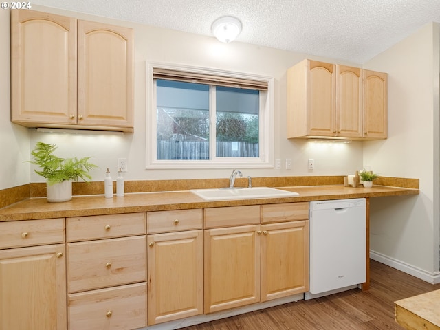 kitchen featuring wood-type flooring, sink, white dishwasher, light brown cabinets, and a textured ceiling