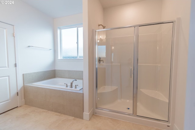 bathroom featuring tile patterned floors and shower with separate bathtub