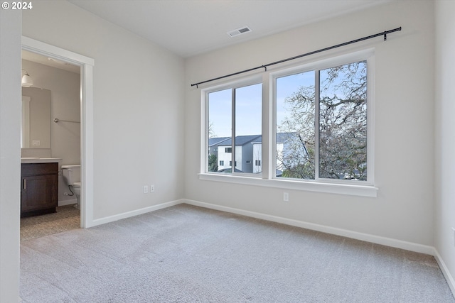 unfurnished bedroom with carpet, visible vents, and baseboards