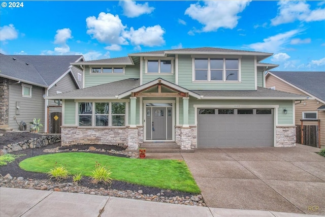 view of front of home with a garage and a front yard