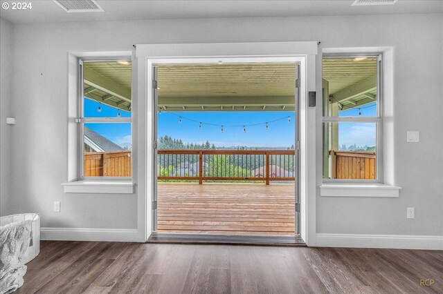 bedroom with a tray ceiling and hardwood / wood-style floors