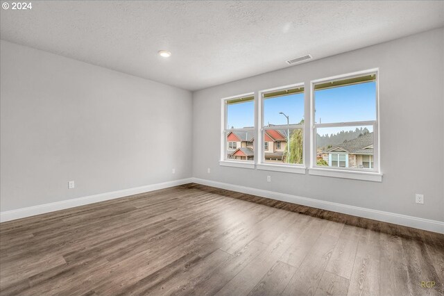 bedroom featuring hardwood / wood-style floors and a textured ceiling