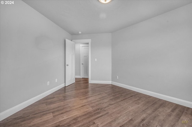 spare room with hardwood / wood-style flooring and a textured ceiling