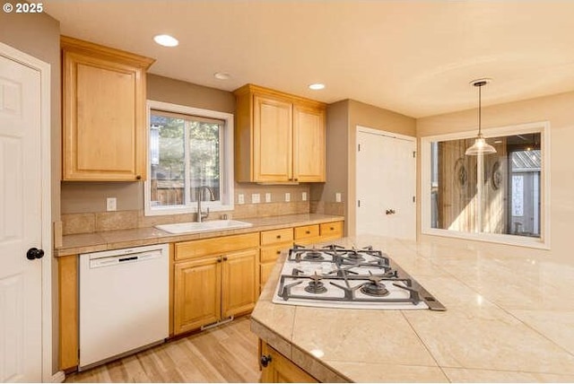 kitchen featuring light brown cabinetry, sink, dishwasher, and gas stovetop