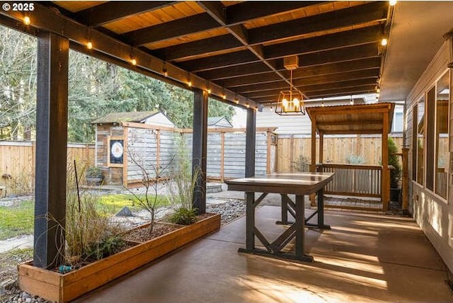 sunroom / solarium with an inviting chandelier